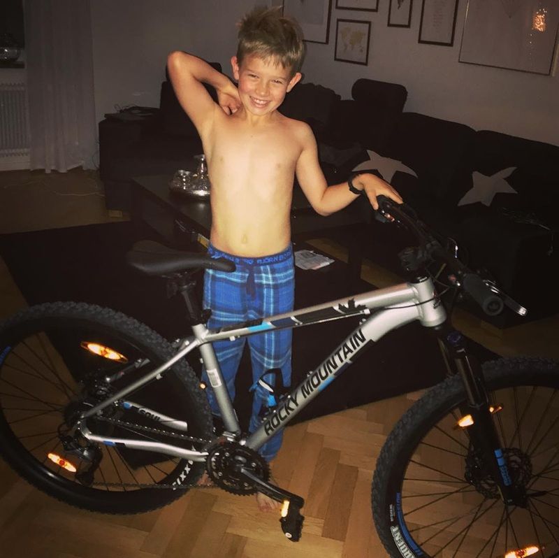 glücklicher Junge mit Geschenk Cross Fahrrad